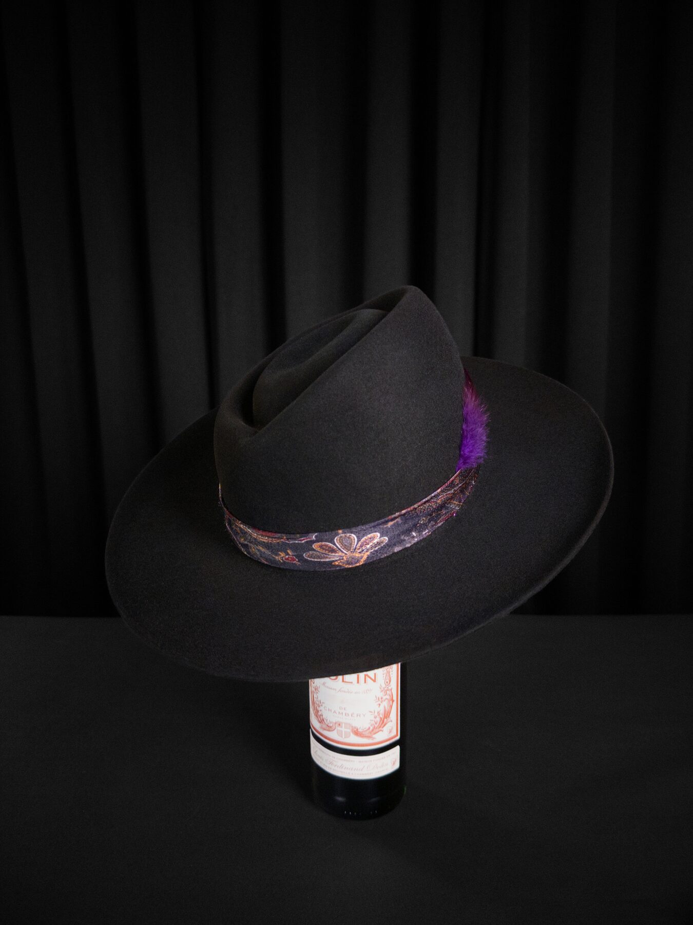 Custom hat band and feather detail on a bespoke fur-felt hat