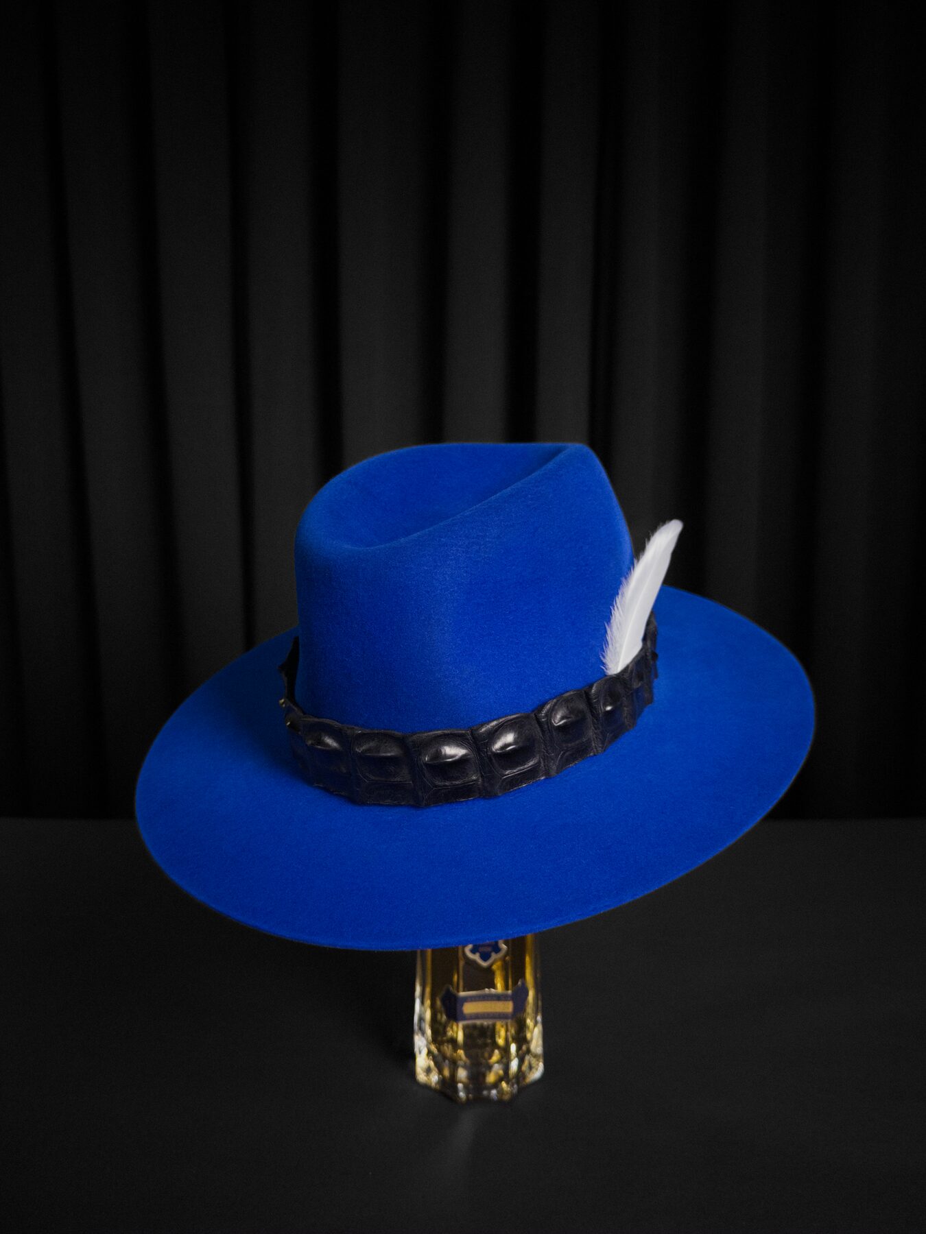 Custom hat band and feather detail on a bespoke fur-felt hat